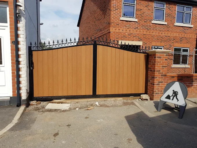 Wood-effect double driveway gates with decorative black metalwork